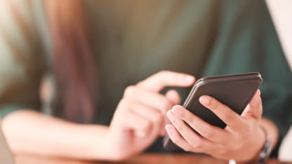 スマートフォンで問い合わせをする手元